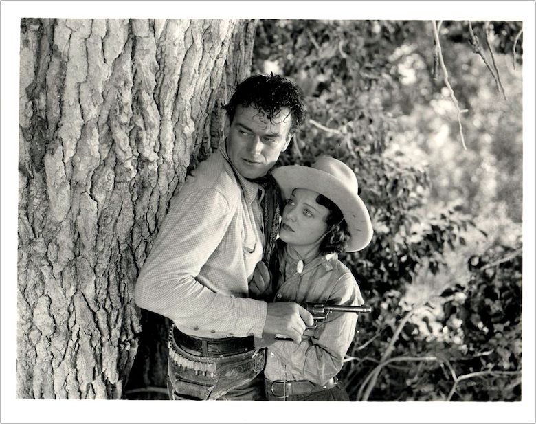 John Wayne and Sheila Manners in the 1935 movie Lawless Range