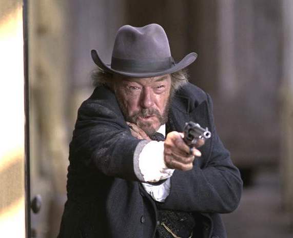 Michael Gambon firing a gun in Open Range