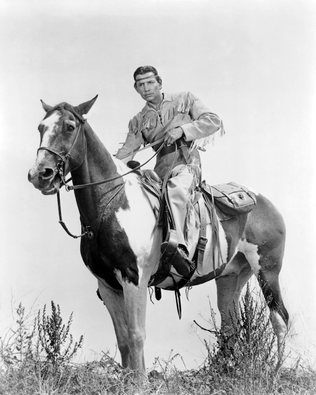 Jay Silverheels as tonto on horse with blank background